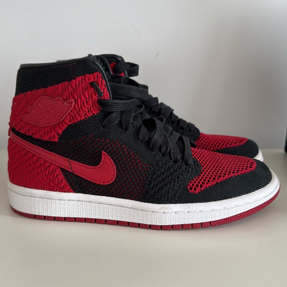 Size 4.5 Y = women’s 6 black and red Jordan 1 Nike 1985 knit exclusive